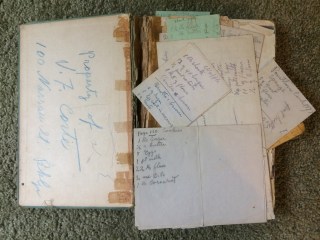 Handwritten recipes on scraps of paper in an old cookbook