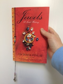 Bookmark cord with beads on the ends inside a book on jewels