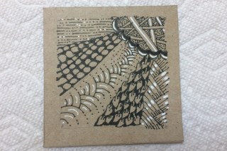 Tan square with Zentangle design in black ink with white accents