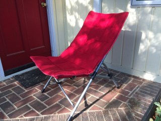 Red upholstered folding chair.