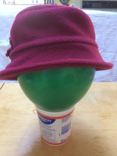 Maroon fleece hat with downturned brim