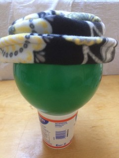 Yellow and black fleece hat with upturned brim.