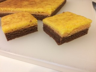 Squares of hot-milk sponge cake with orange and cocoa layers, broiled like sarawak cake