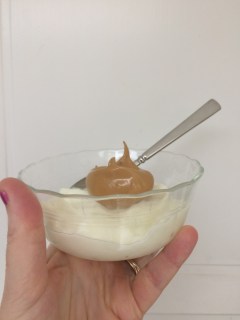 A bowl of plain yogurt with a blob of Dalgona whipped coffee on top