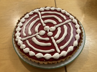 Cranberry curd tart with whipped cream design