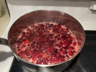 Cranberries boiling in a pot of water