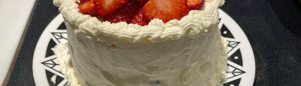 Round layer cake with whipped cream and fresh fruit topping.